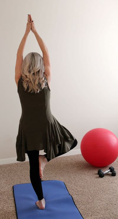 A woman performing yoga in her home