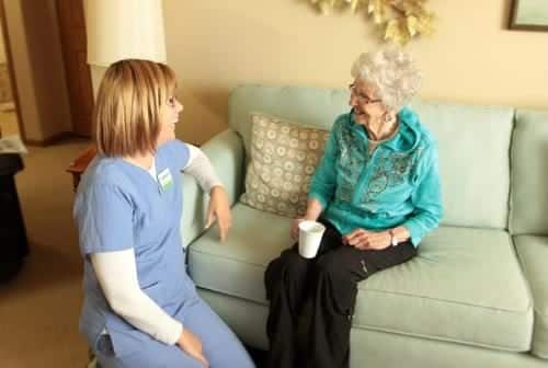 nurse and senior talking