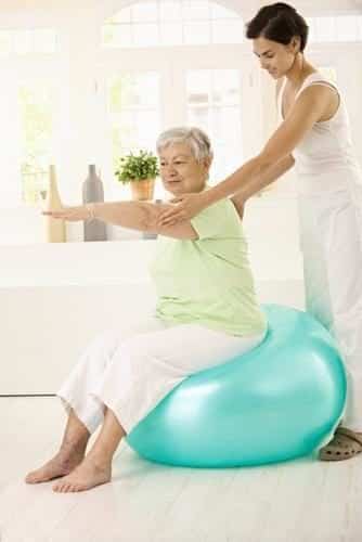 Senior exercising with trainer.