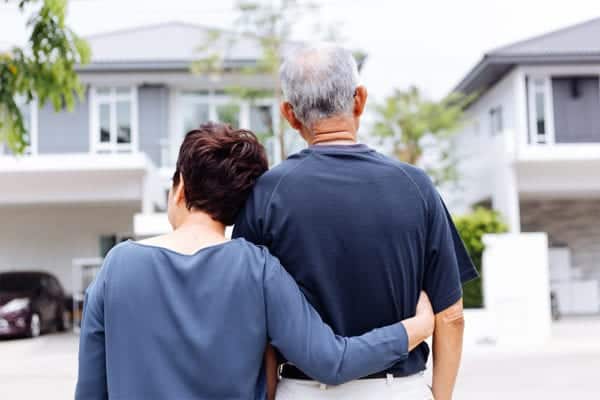 Daughter and father looking at house.