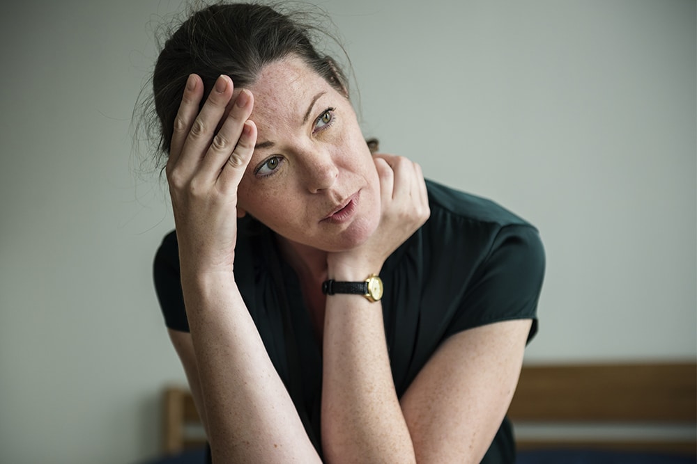 Stressed woman sitting.