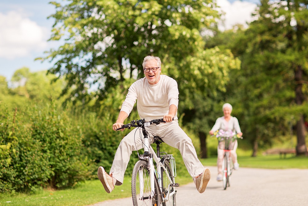 A man and woman riding bike. 