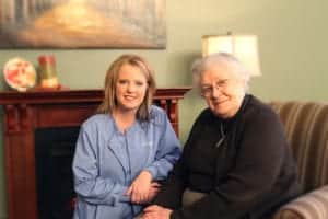 Edgewood nurse sitting with resident