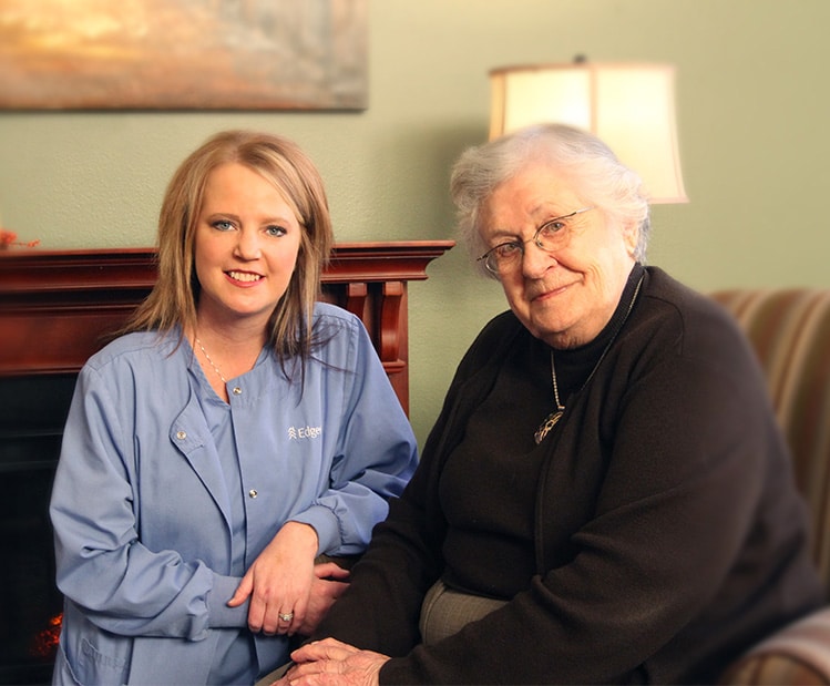 Edgewood nurse sitting with resident