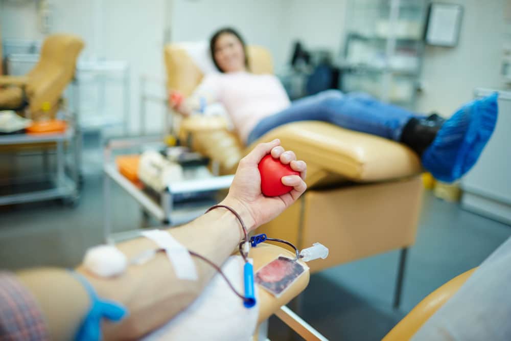 A blood donor grips a hand flexor at a blood drive