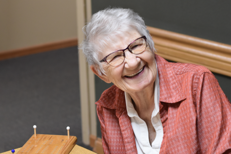 a female senior having fun playing cribbage
