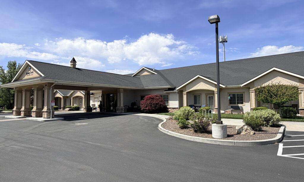 exterior photo of tan building with blue skies