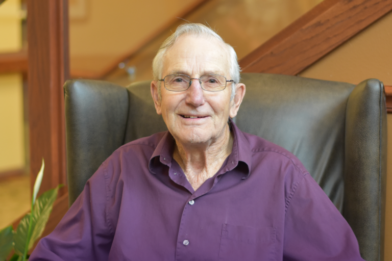 a male senior wearing a purple shirt