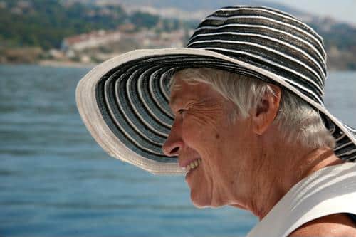 Senior female wearing black and white striped beach hat