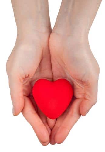 hands holding red heart shaped object