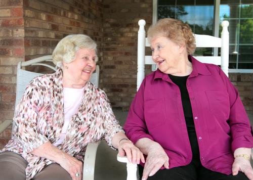 Senior females sitting outside on patio