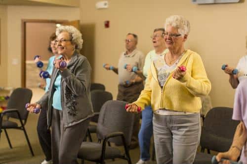 Seniors in exercise class holding hand weights