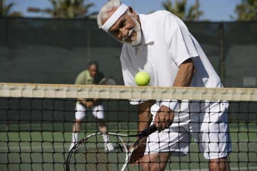 Edlerly male holding tennis racket