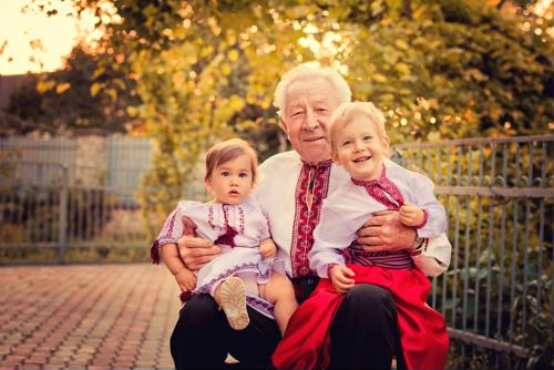 Male senior with two children on lap