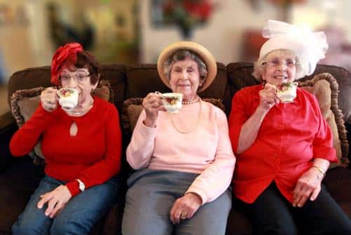 Three senior females holding teacups