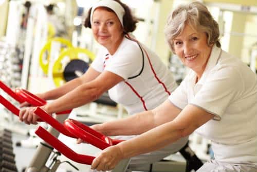 Female seniors on exercise bikes