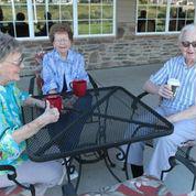 Seniors on patio with coffee cups