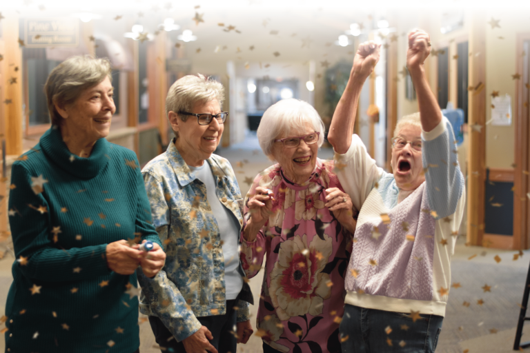 4 senior female residents standing