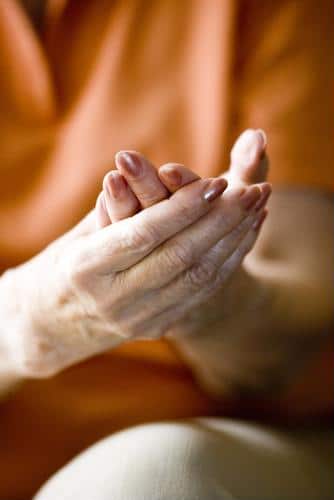 Female with painted fingernails holding hands together