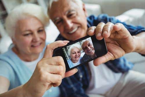 Senior couple taking selfie