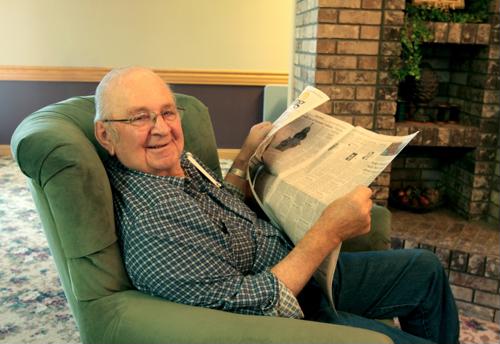 Senior male reading newspaper