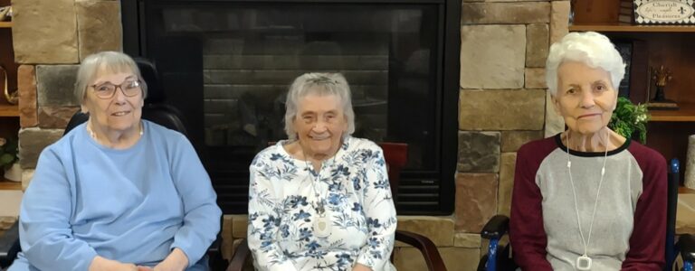 Three senior females seated