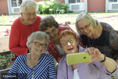 Group of female seniors looking at phone