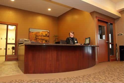 Female seated at reception desk