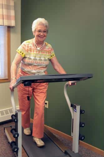 Senior female walking on treadmill