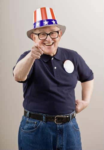 Senior male wearing patriotic hat and button