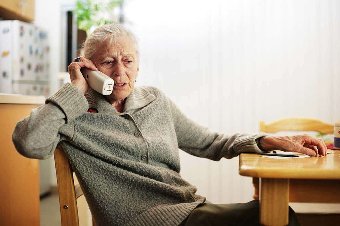 Female senior holding cordless telephone