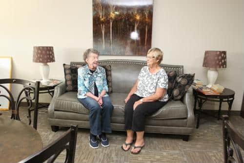 Two females seated on couch
