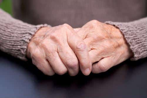 Hands held together in lap