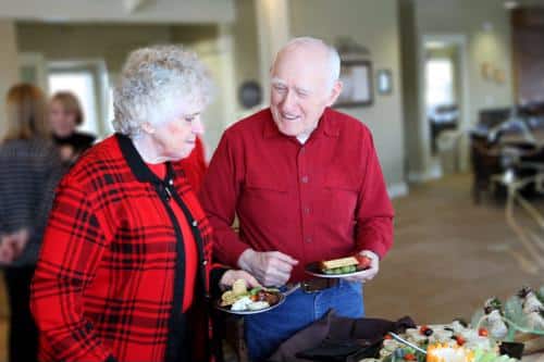 Senior couple with plates of food