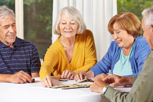 Seniors playing game with tiles