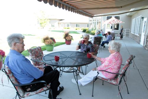 Seniors on patio with coffee cups