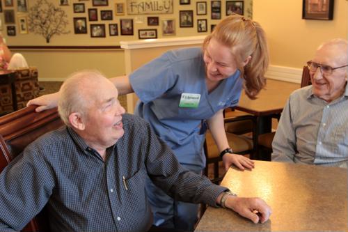 Male seniors seated with female caregiver