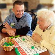 Caregiver and female senior with bingo card