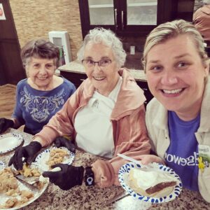 Female residents and staff picutred with pies