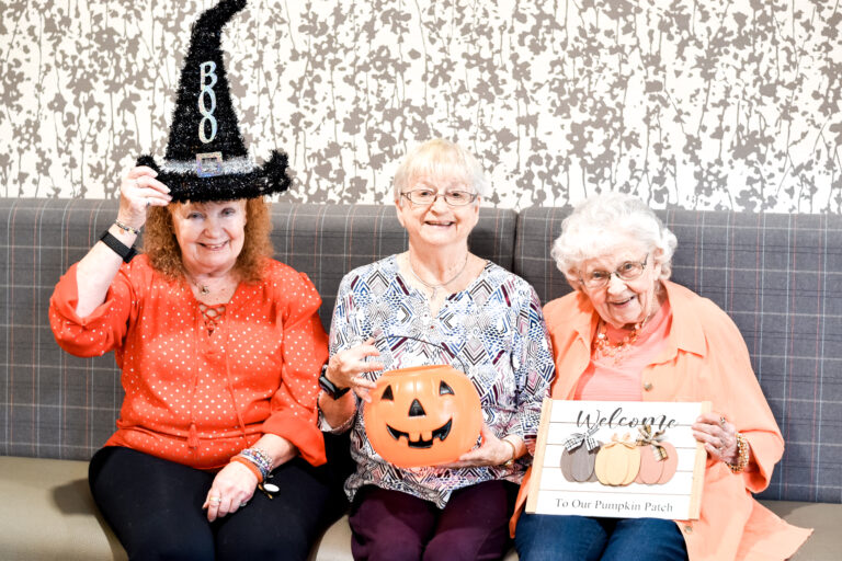 Three female residents with halloween decor