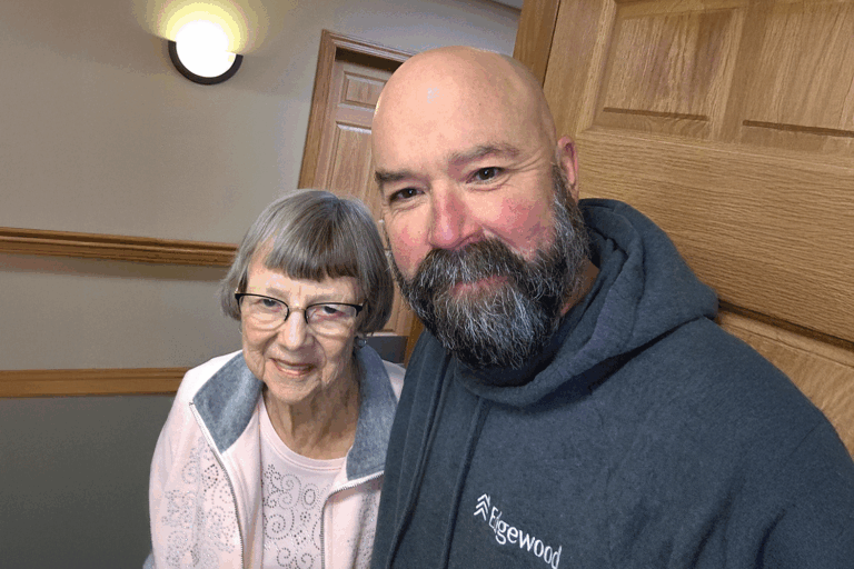 Staff member Kale Swenson, RN, and Resident Donna.